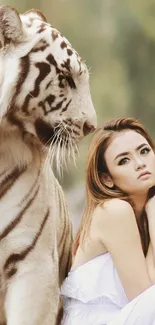 Woman in white with a gentle white tiger in a tranquil forest setting.