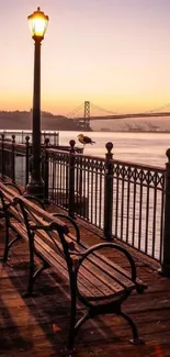 Peaceful bridge during sunset with violet skies and glowing lights.