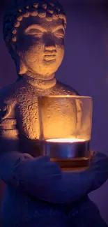 Buddha statue holding candle in soothing blue light.