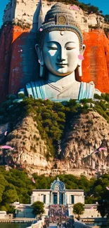 Buddha statue carved in red mountain with lush greenery.