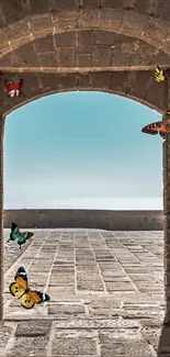 Butterflies flutter through a stone arch with a blue sky backdrop.