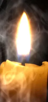 Candle with a bright flame and soft smoke against a dark background.