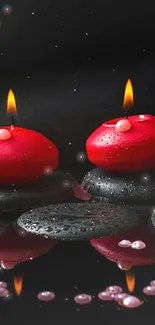 Red candles and floral accents on reflective black stones.