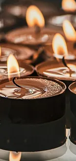 A collection of lit candles creating a warm, serene atmosphere.