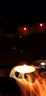 Mobile wallpaper with glowing candle flames against a dark background.