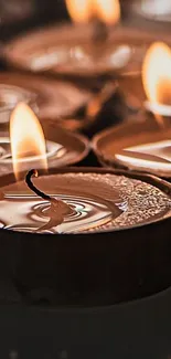 Lit candles with glowing orange flames creating a warm, serene ambiance.