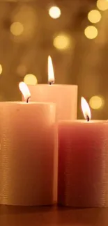 Three glowing candles with a warm beige background.