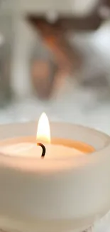 Minimalist candle glowing softly in cozy setting.