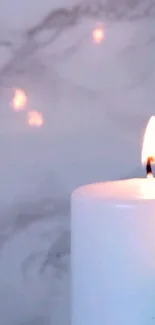 Serene candle glowing against marble background.