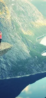 Yoga on a cliff with scenic mountain and lake view.