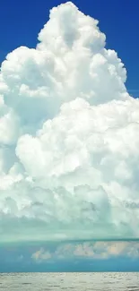 Vast blue sky with white clouds over a calm ocean.