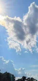 Cloud shaped as a butterfly under the sun in a bright blue sky.