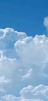 Fluffy white clouds against a blue sky, mobile wallpaper.