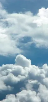 Serene wallpaper with fluffy white clouds against a blue sky.