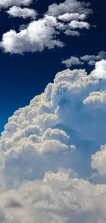 Cloudy sky with deep blue tones and white clouds in a serene scene.