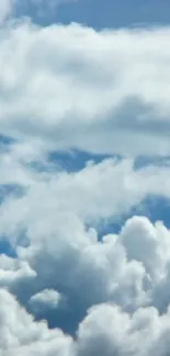 Serene sky with fluffy white clouds in blue background.