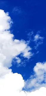 Mobile wallpaper with a vibrant blue sky and fluffy white clouds.