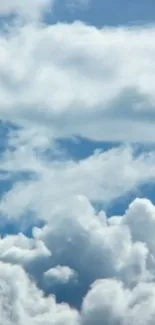 Fluffy white clouds against a blue sky.