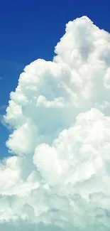 Fluffy white clouds against a clear blue sky - perfect mobile wallpaper.