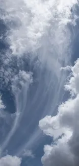 Serene cloudy sky with dramatic clouds over a deep blue backdrop.