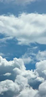 Tranquil cloudy sky with fluffy white clouds against a clear blue backdrop.