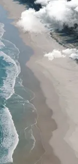 Aerial view of beach with azure waves, white sand, and clouds.