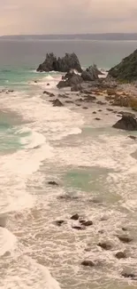 Serene coastal scene with waves and rocky shore.