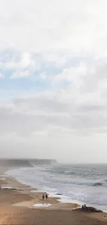 Serene beach scene with ocean and sky.