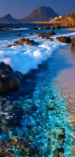 Beautiful coastal beach with blue sea and rocky shore under a clear sky.