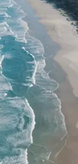 Aerial view of turquoise ocean waves and sandy beach coastline.