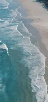 Aerial view of a serene beach with gentle ocean waves and sandy shores.