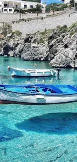 Blue boats float in clear turquoise waters by rocky cliffs and a charming village.