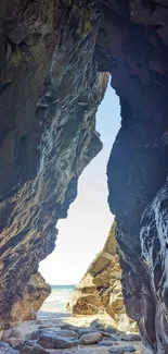 A stunning view through a coastal cave opening to the ocean beyond.