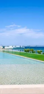 Infinity pool with ocean view and clear blue sky.