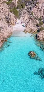 Aerial view of turquoise waters surrounded by rocky cliffs and a hidden beach.