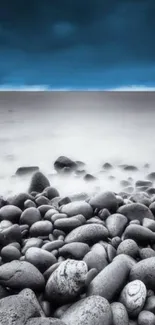 Serene coastal view with pebbles and blue sky wallpaper.