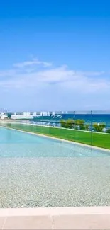 Infinity pool with ocean view and blue sky.