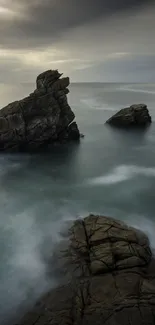 Majestic coastal rock formation with serene sea and sky.