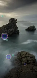 Serene coastal view with rocks and floating bubbles at sunset.