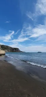 Coastal view with blue sky and ocean waves, perfect for mobile wallpaper.