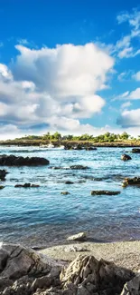 Coastal landscape with blue skies and rocky shore.