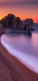 Serene coastal sunset with orange hues over the calm ocean.