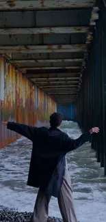 Person standing in a serene coastal tunnel.