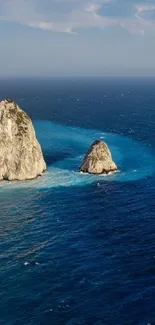 Serene coastal landscape with blue ocean and rocky cliffs.