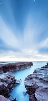 Serene coastal view with rocky shores and vibrant blue sky.