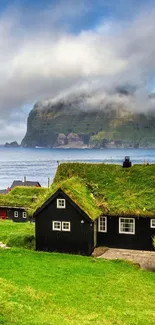 Serene coastal village with lush green roofs and misty mountains.