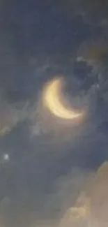 Crescent moon with clouds in a night sky.