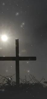 Silhouetted cross against a serene, starry night sky.