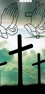 Three crosses beneath praying hands in a misty sky wallpaper.