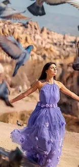 Woman in a purple dress with birds in a desert landscape.